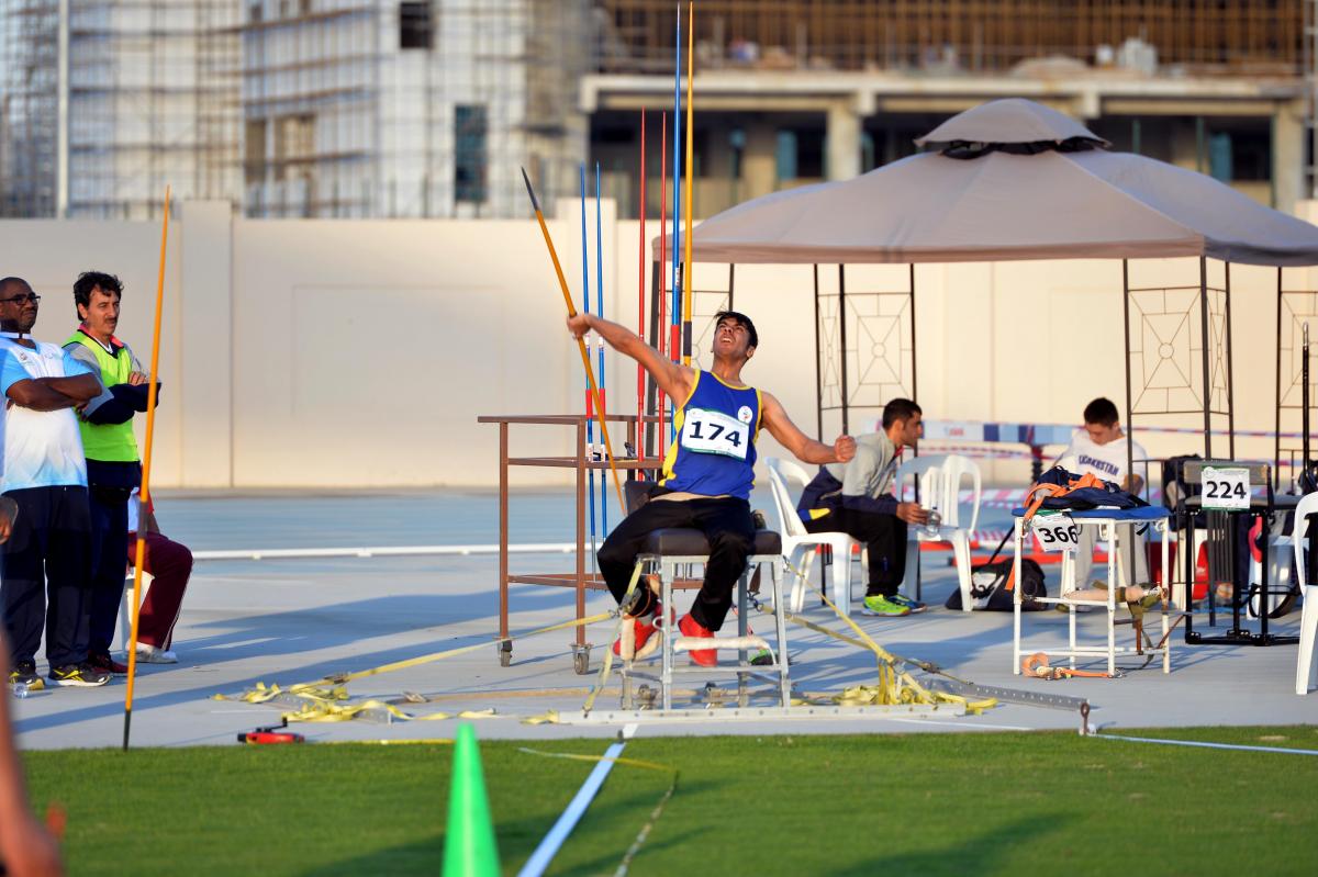 a male Para athlete throws a javelin