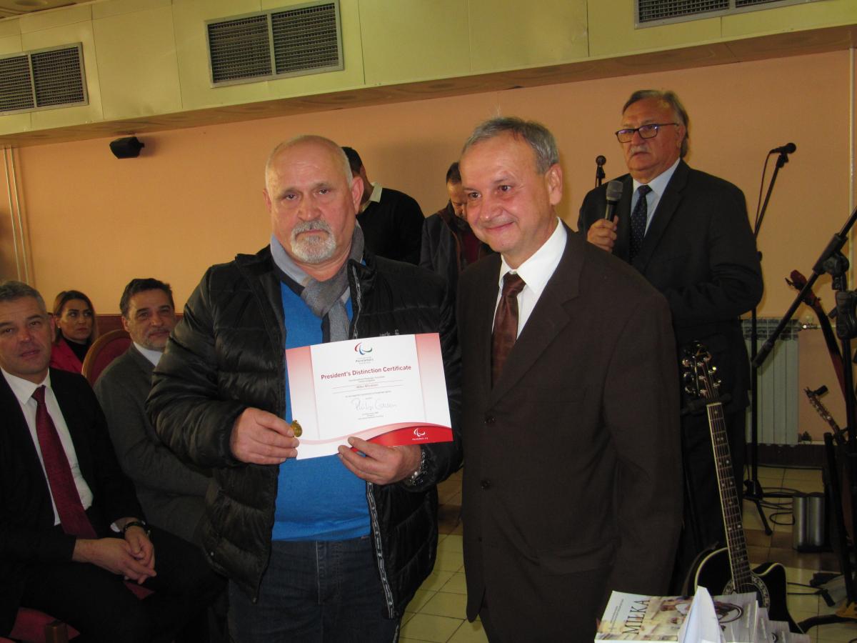 Milka Milinkovic's brother Milan Two men holding up a certificate