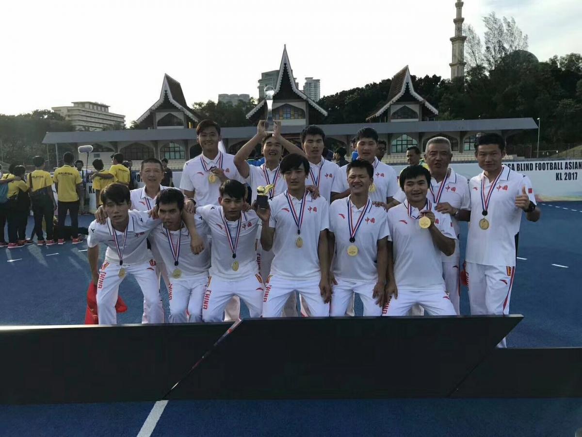China win Asian Championships - football 5 a side a group of blind footballers celebrate with their medals and trophies