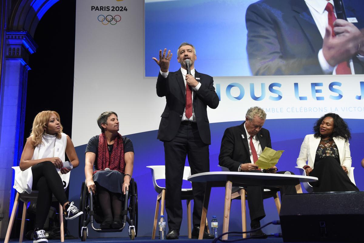 Etienne Thobois - Paris 2024 a man speaks into a microphone on stage