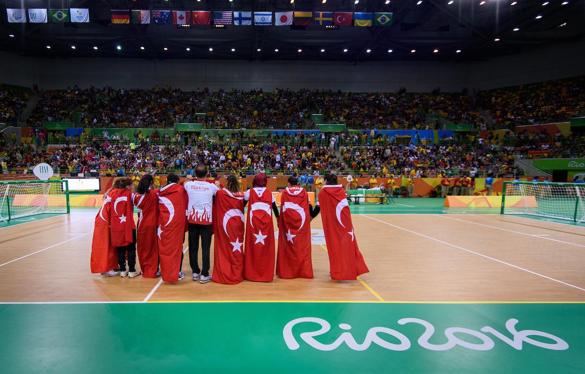 Turkey goalball women - Rio 2016 a group of women hug under the Turkish flag