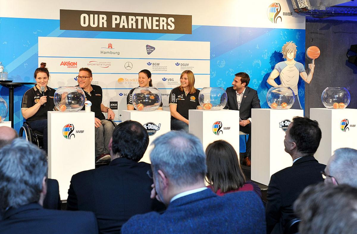 Hamburg 2018 wheelchair basketball draws Athetes in wheelchairs draw names out of a bowl