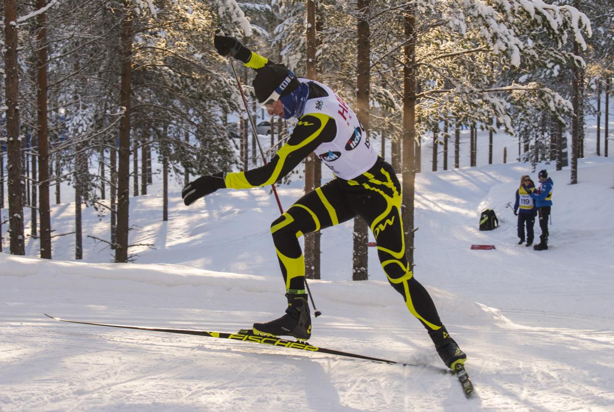 Male standing biathlete racing