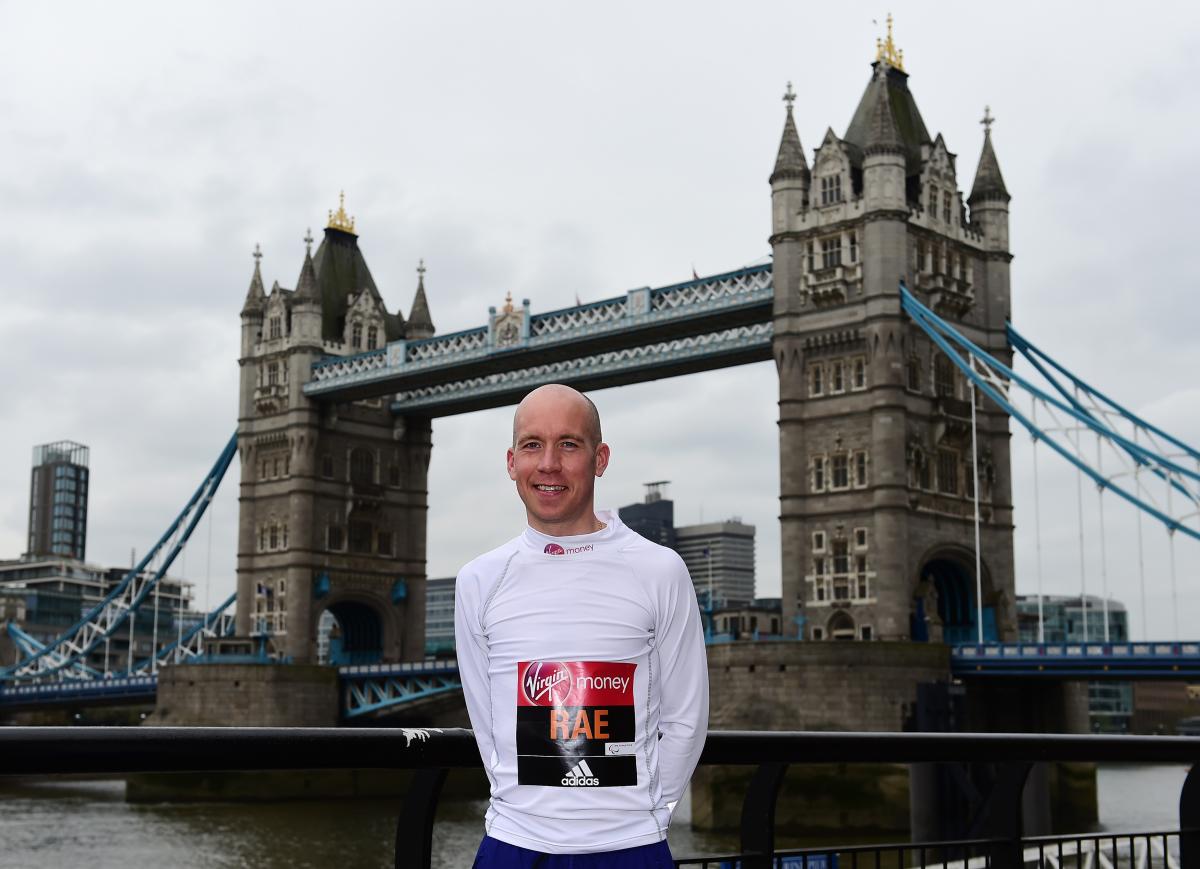 Derek Rae a man standing in front of London's Tower Bridge