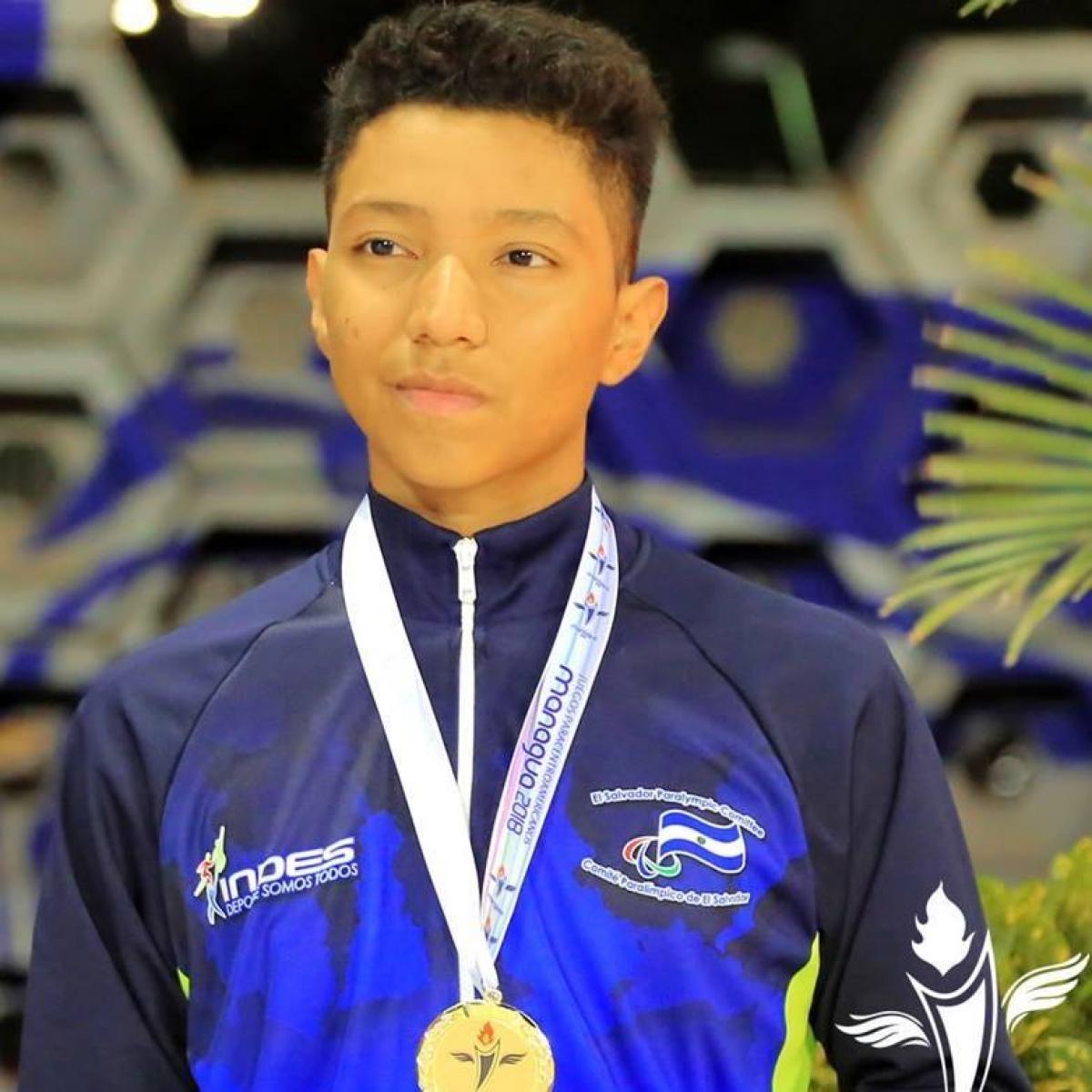 Fernando Fuentes - Managua 2018 a male Para swimmer stands on the podium with a gold medal round his neck
