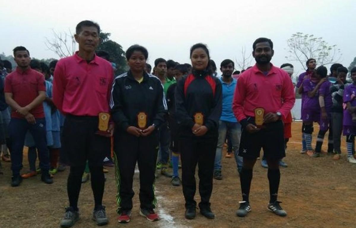 two male and two female referees stand side by side