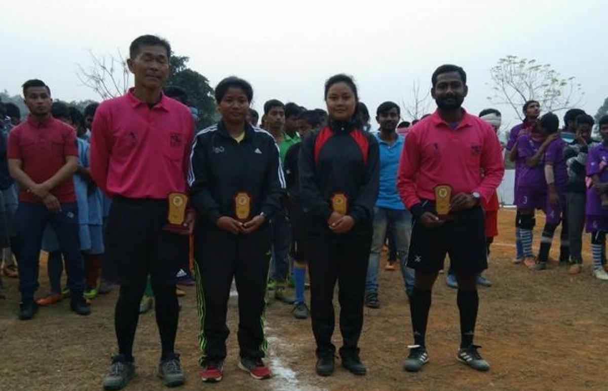 Female blind football referees two male and two female referees stand side by side