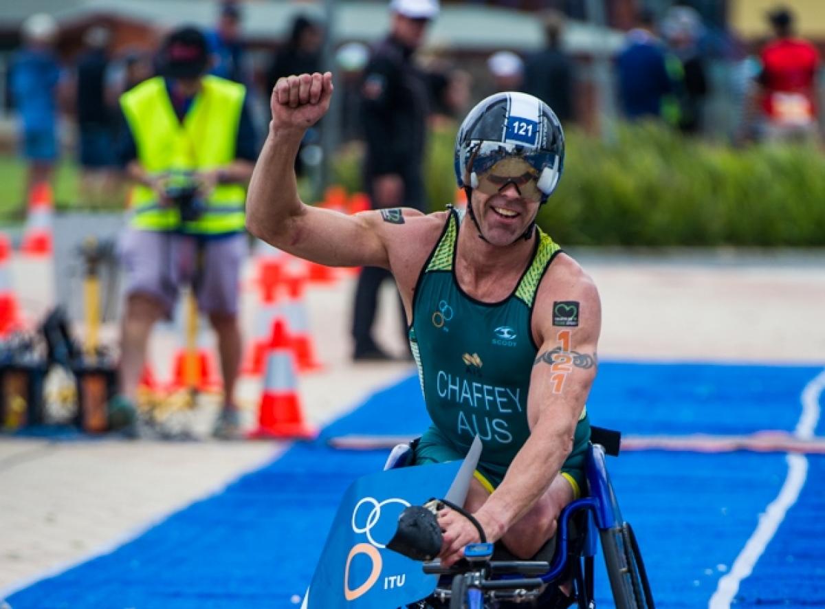 Triathlete celebrates crossing finishing line