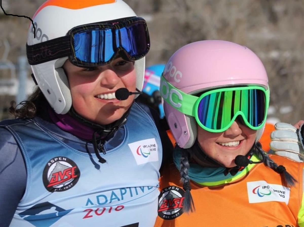 a female vision impaired skier and her guide