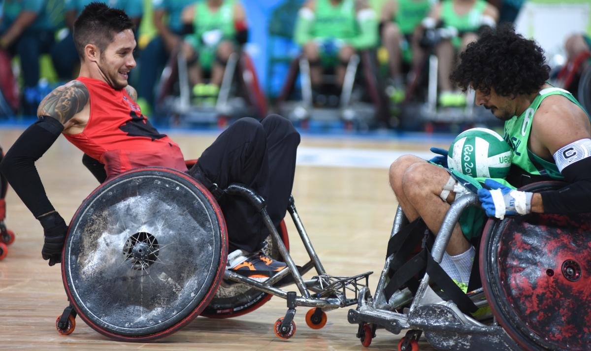 Trevor Hirschfield two male wheelchair rugby players clash for the ball