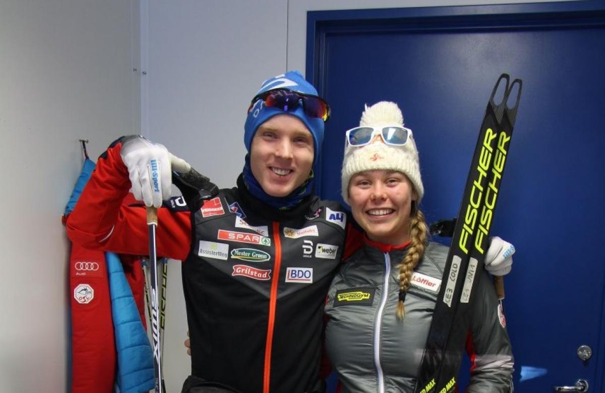 a male and female Para Nordic skier smiling together