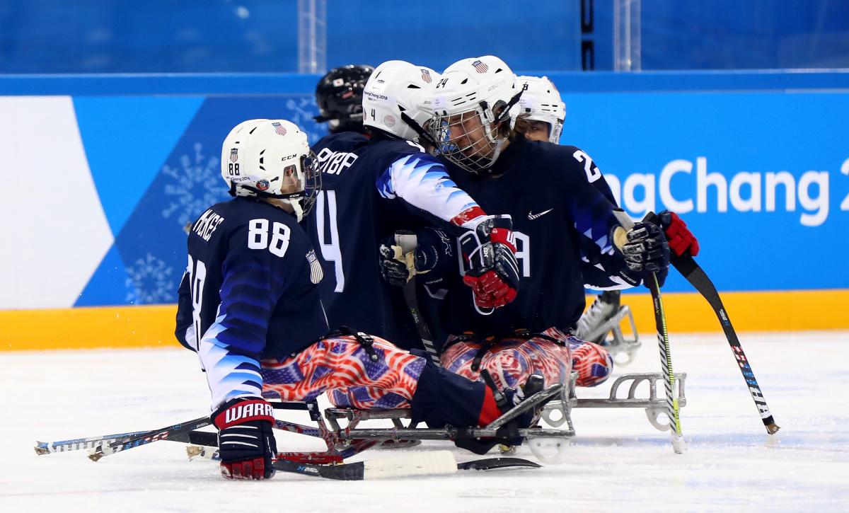 Brody Roybal USA - PyeongChang 2018 a group of Para ice hockey players celebrating a goal
