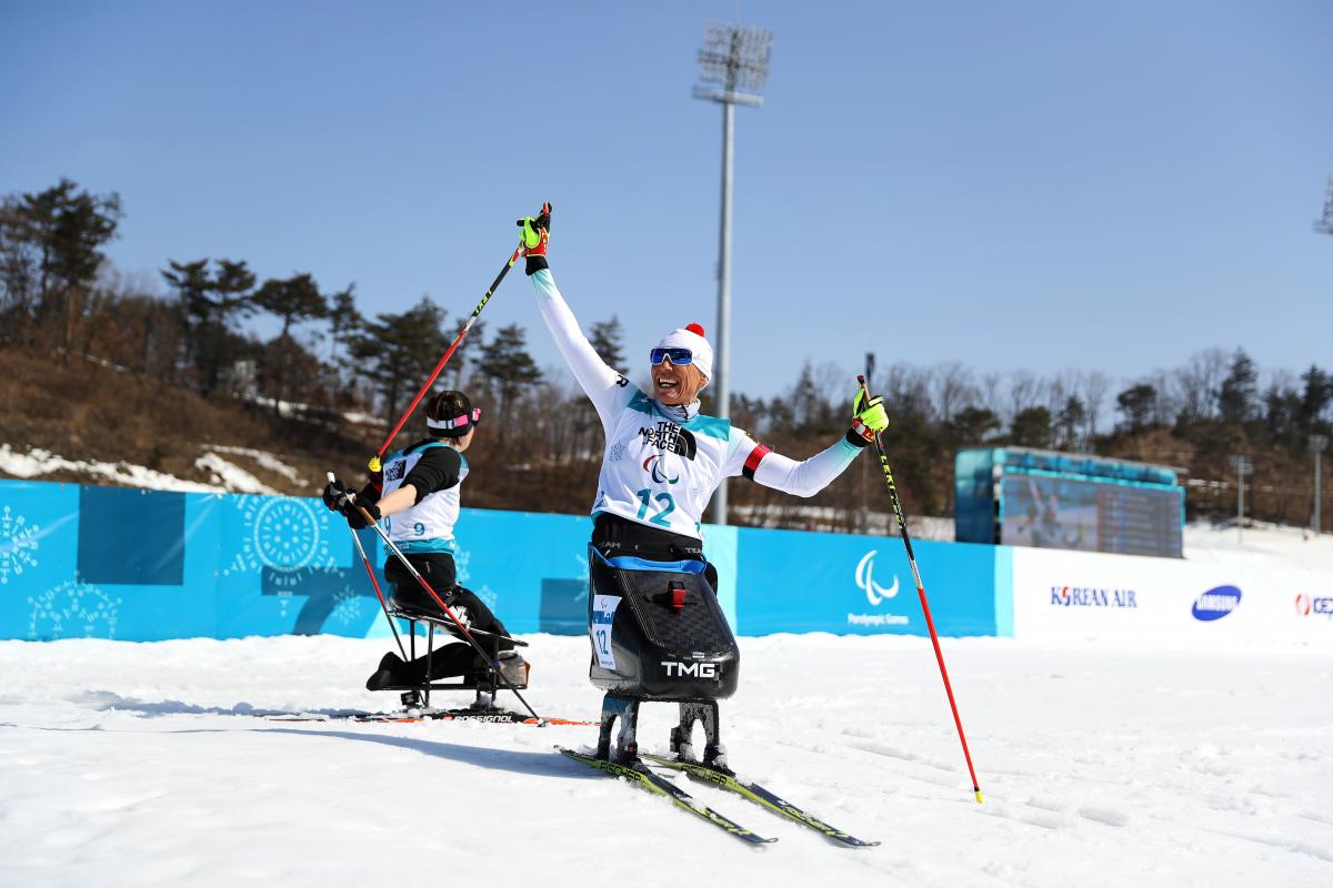 Andrea Eskau - PyeongChang 2018 a female Nordic sit skier celebrates on the finish line