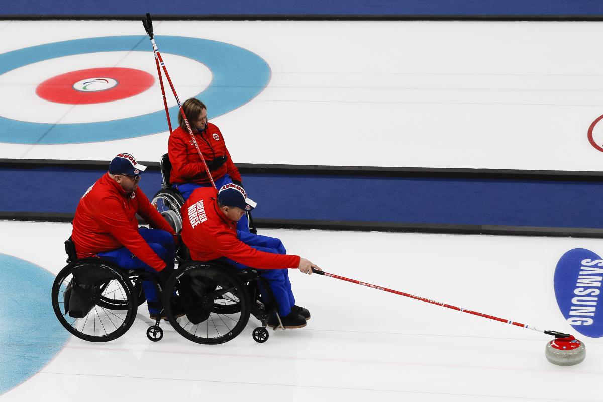 Norway wheelchair curling - PyeongChang 2018 wheelchair curler throws a stone