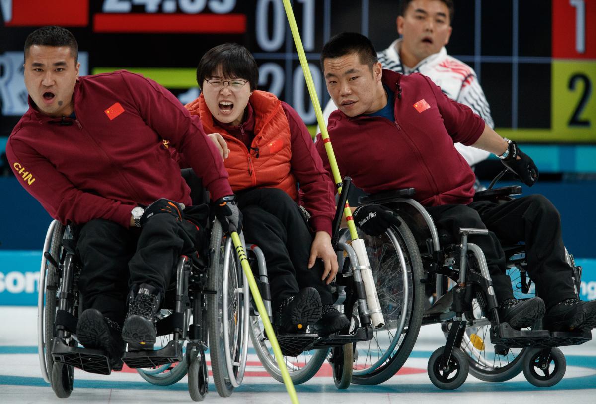 China wheelchair curling - PyeongChang 2018 wheelchair curlers watching a stone