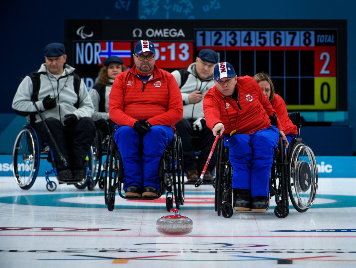 a wheelchair curler plays a stone