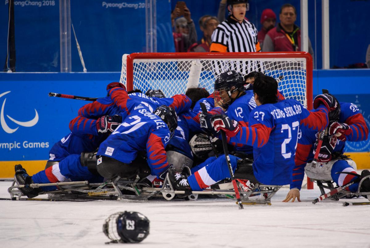 Para ice hockey players celebrating