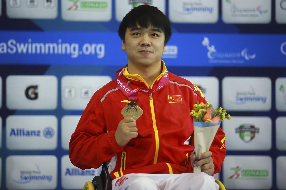 a male Para swimmer on the podium