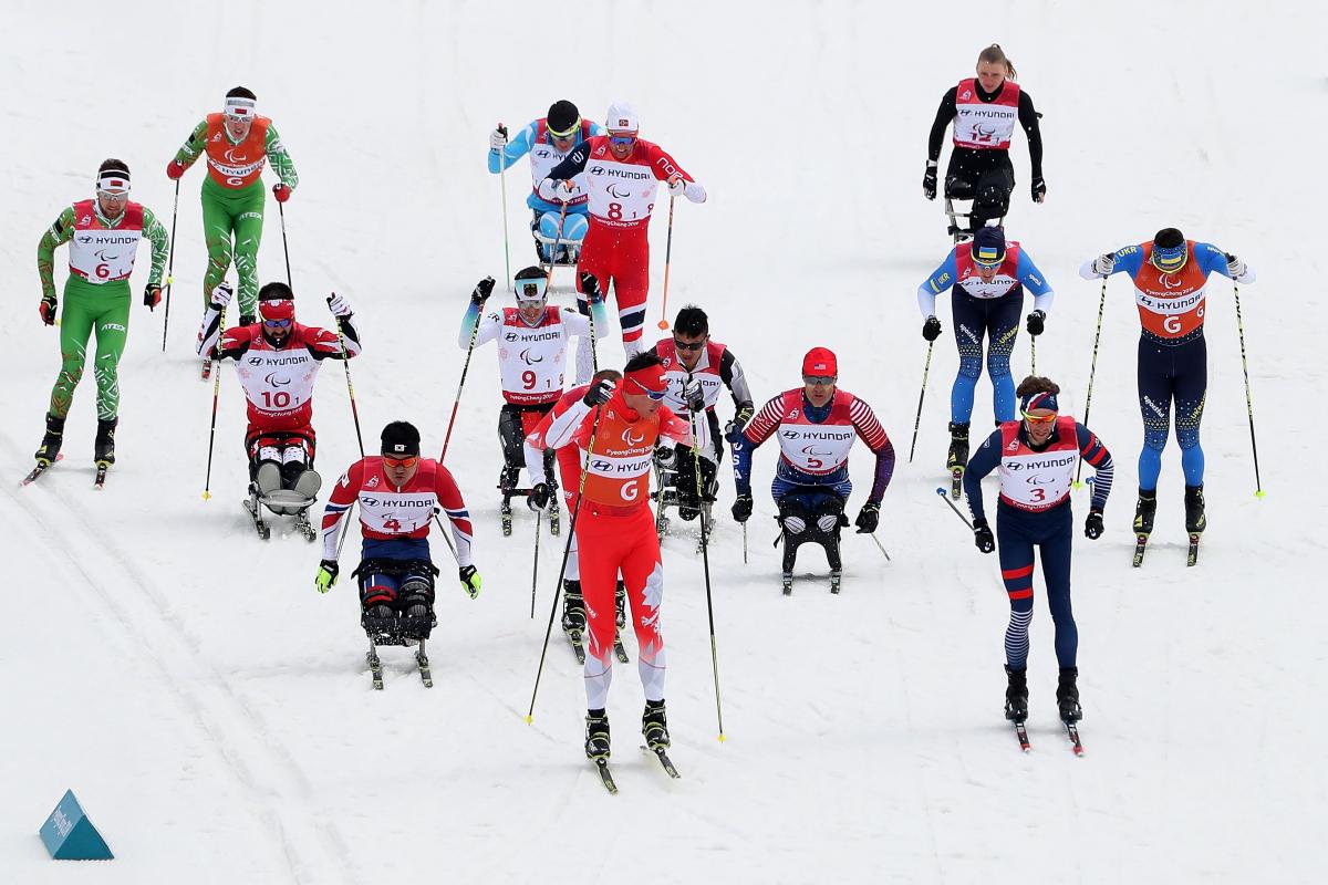 Cross-country relay - PyeongChang 2018 a group of cross-country skiers sprint for the finish line