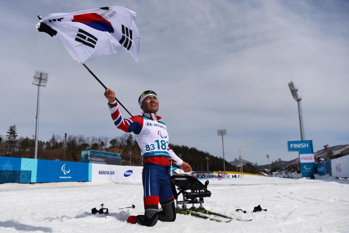 Eui Hyun Sin - PyeongChang 2018 a male Para Nordic skier celebrates with the South Korean flag