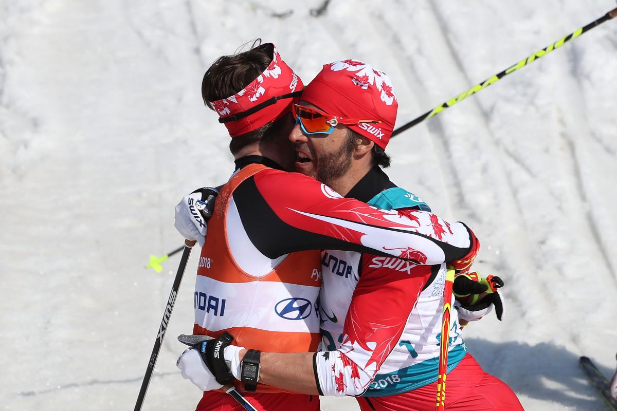 Brian McKeever - PyeongChang 2018 a visually impaired skier and his guide hug on the finish line