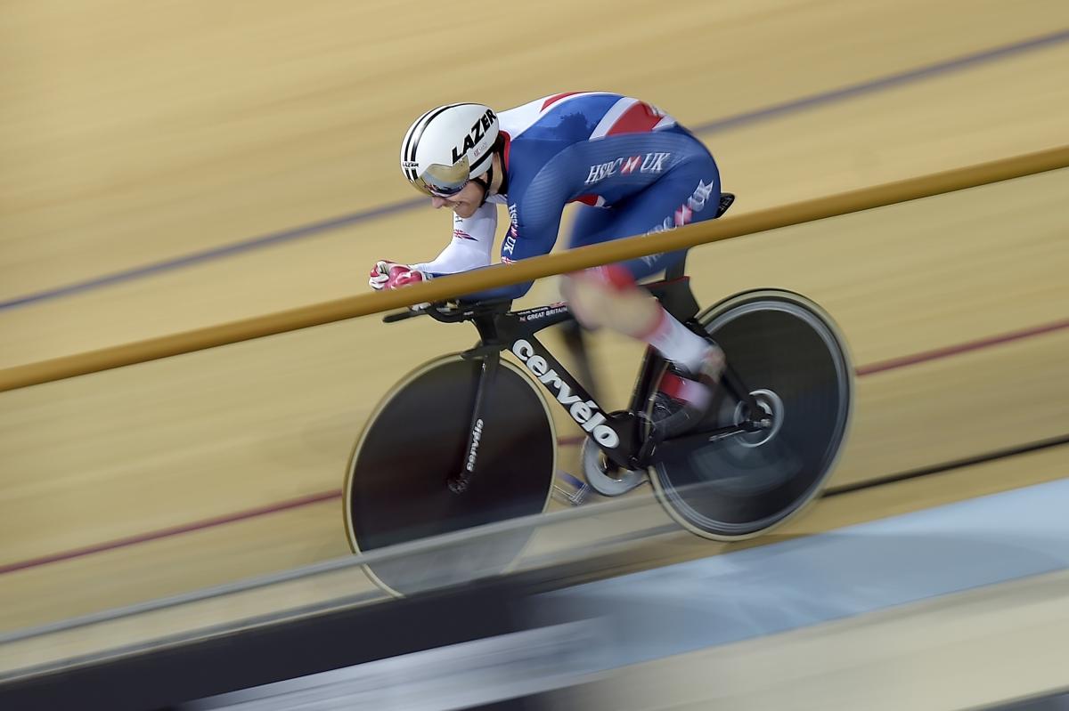 a male Para cyclist racing around a track