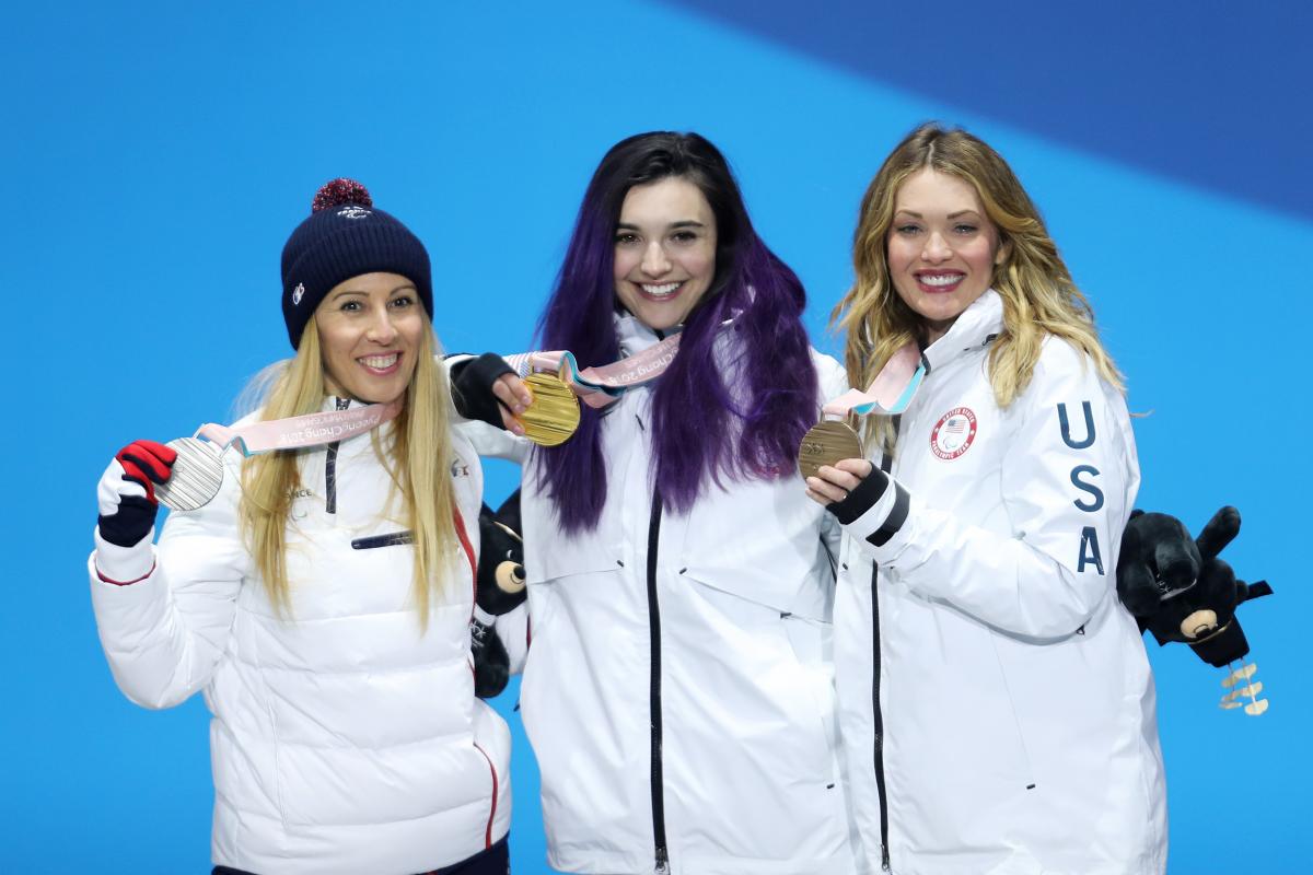 three female Para snowboarders on the podium