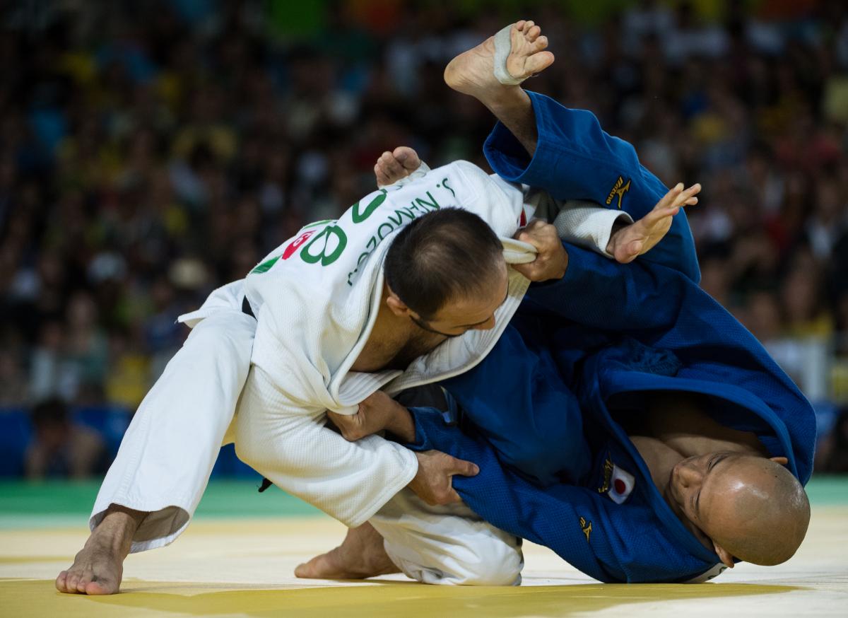 two male judokas in a fight position