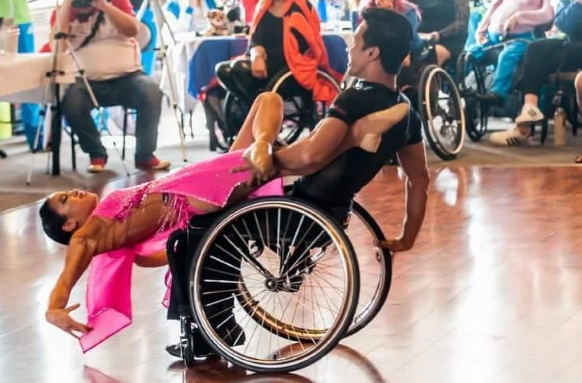 a Para dance couple in a pose on the dance floor