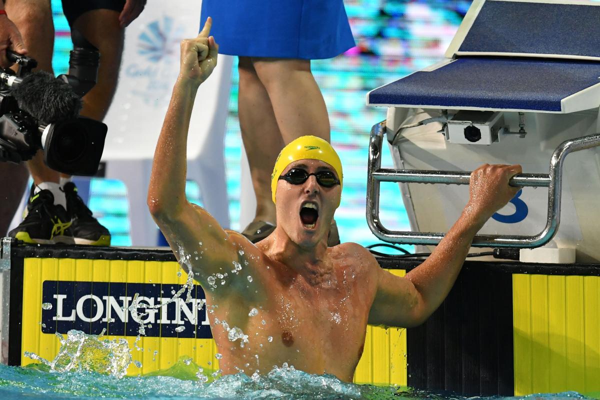 a male Para swimmer punches the air 