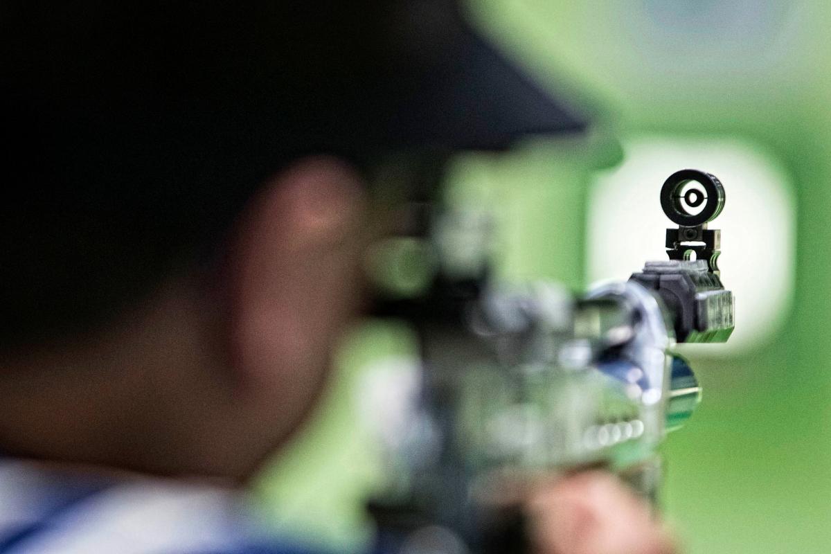 Athlete with a rifle aiming at a target