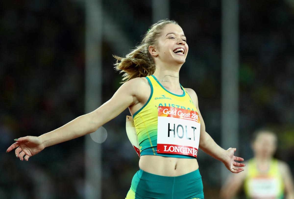 a female Para sprinter crosses the finish line