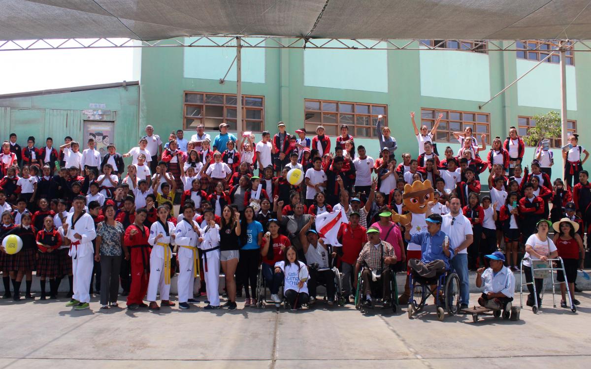 a group of Para athletes and schoolchildren