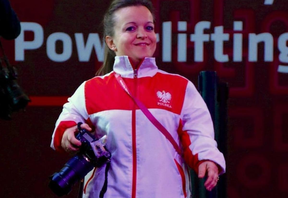 a female powerlifter with a camera