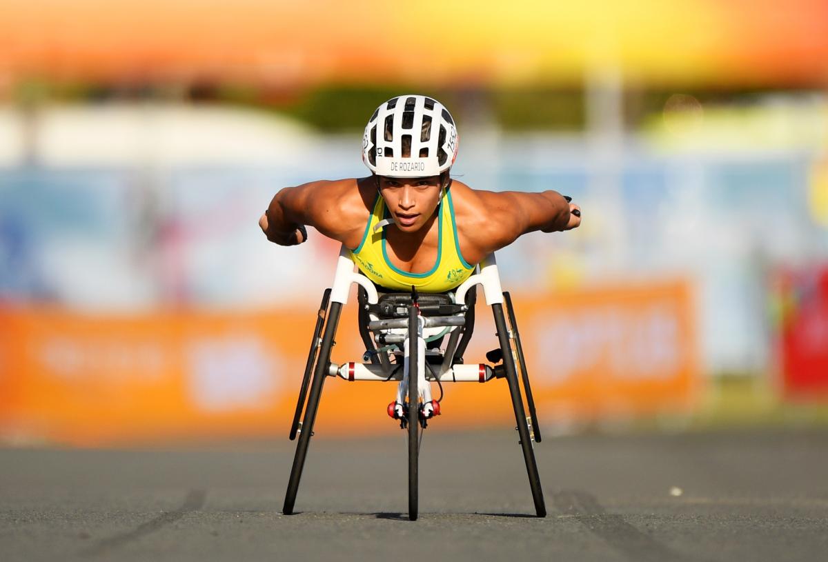 a female wheelchair racer sprints towards the line