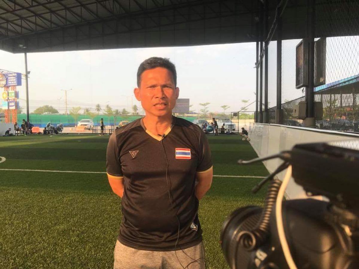 a man standing in front of a football pitch