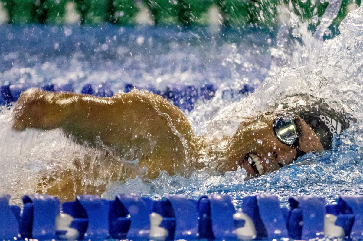 a male Para swimmer mid-freestyle stroke