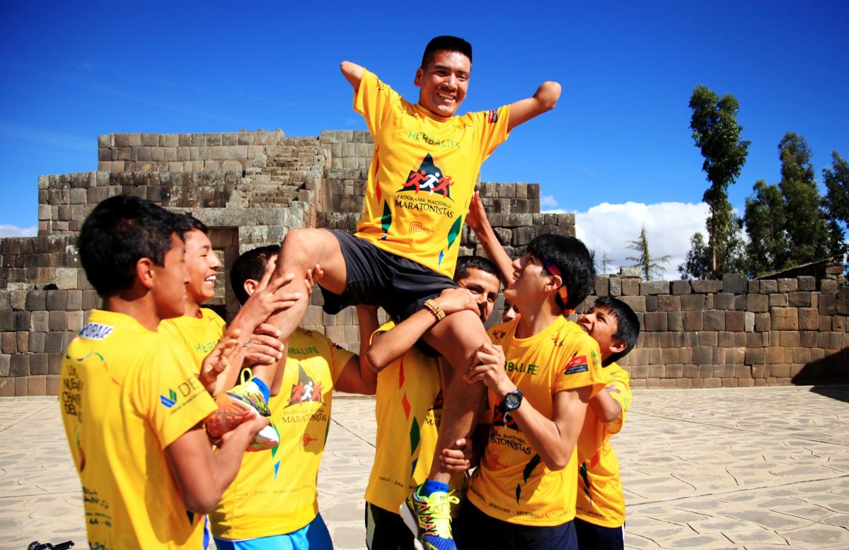 a Para athlete held on the shoulders of other athletes