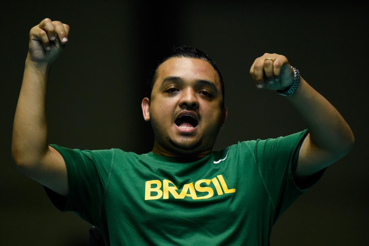 a male boccia player celebrates a throw