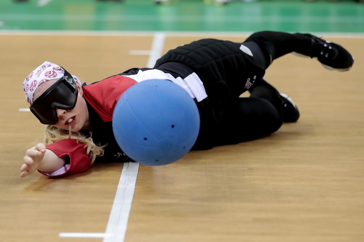 a female goalball player saves a shot