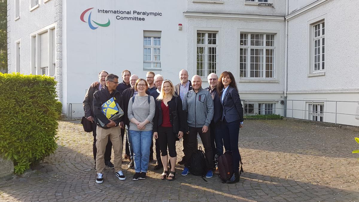 Group of people standing for picture in front of the IPC headquarters in Bonn