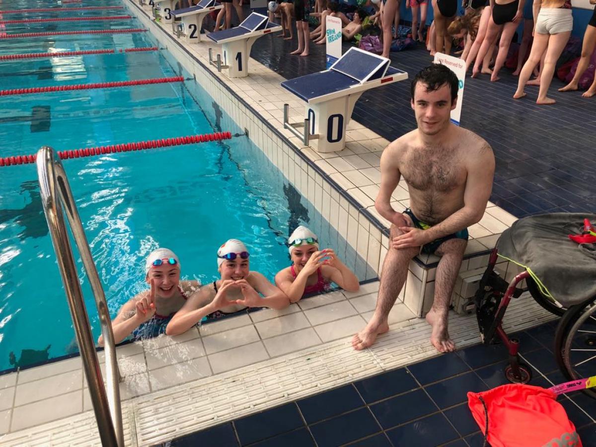 Dublin 2018 - 100 Days to Go Three swimmers in the pool and one swimmer out of the pool posing for a picture