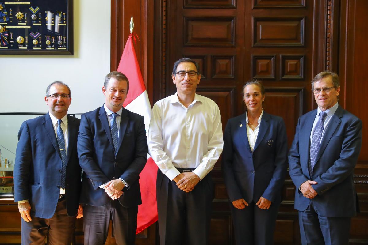 four men and a woman lined up for a photo