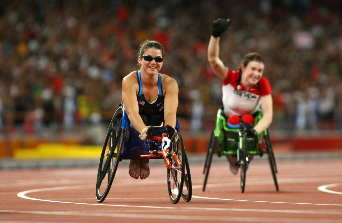 Jessica Galli - Beijing 2008 a female wheelchair racer celebrates after the finish line
