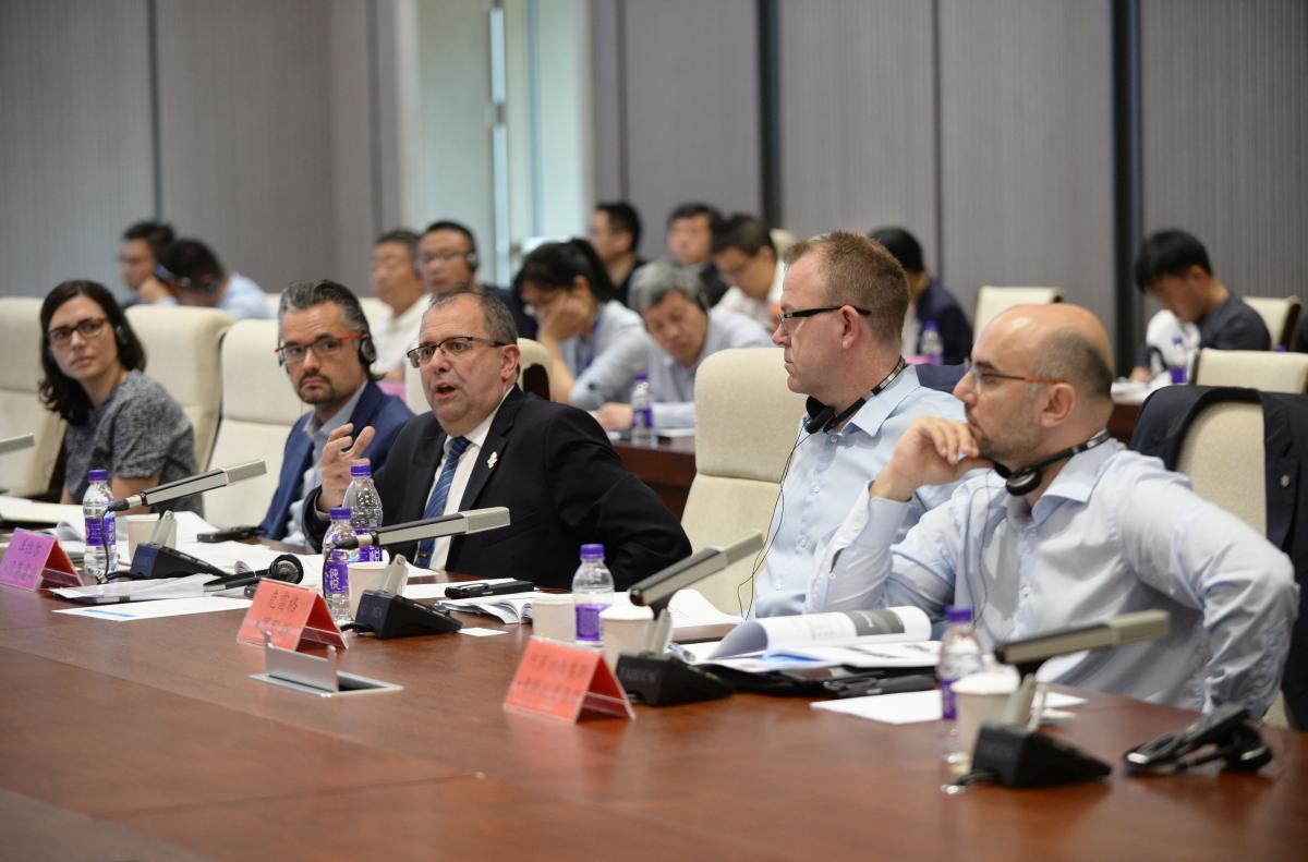Beijing 2022 Project Review - Xavier Gonzalez a group of men speaking at a table