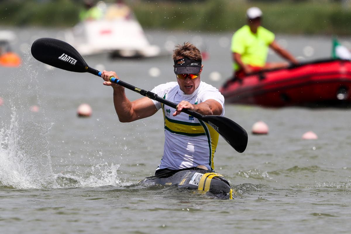 a male Para canoeist mid-stroke