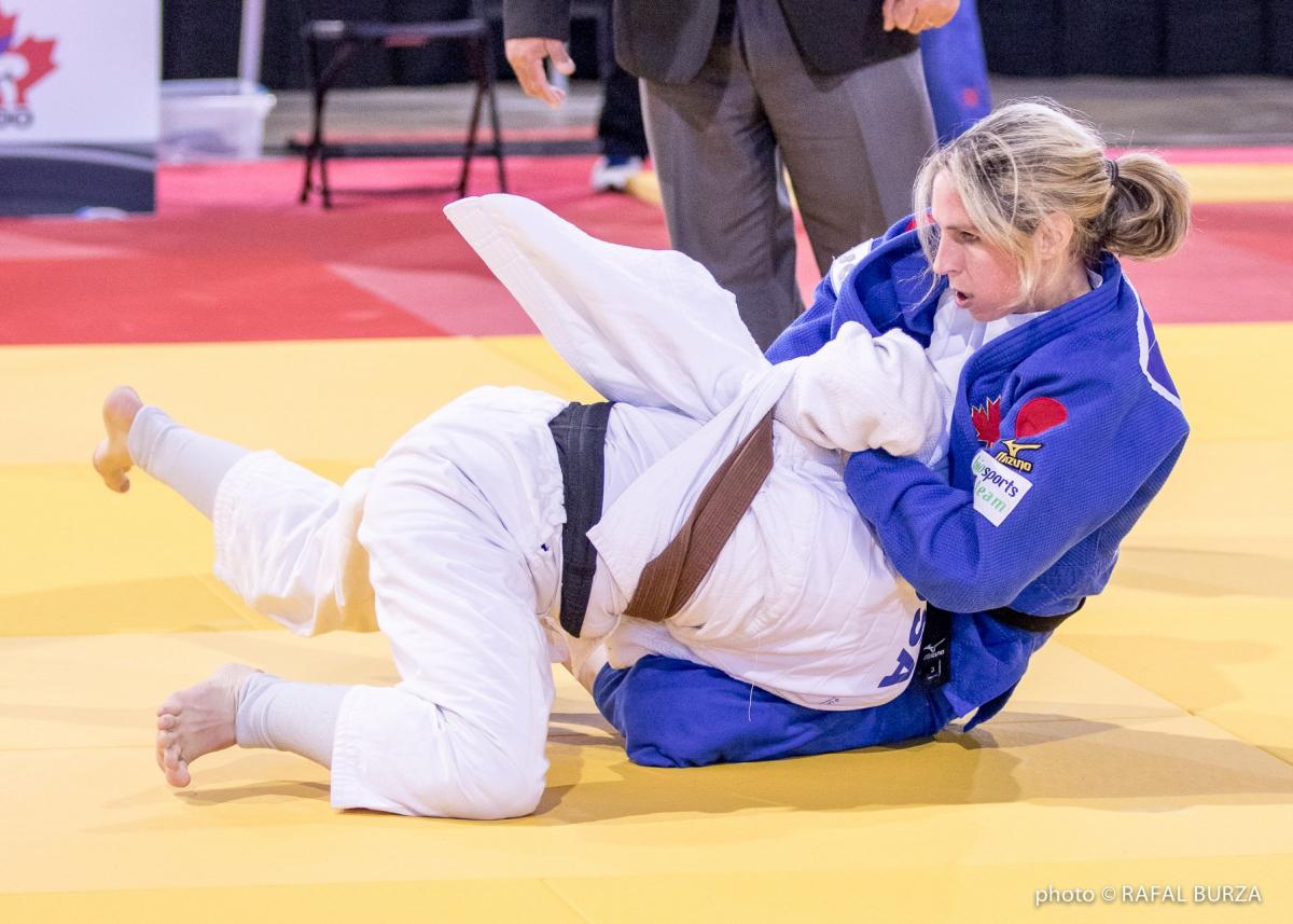 two female judokas in action on the mat