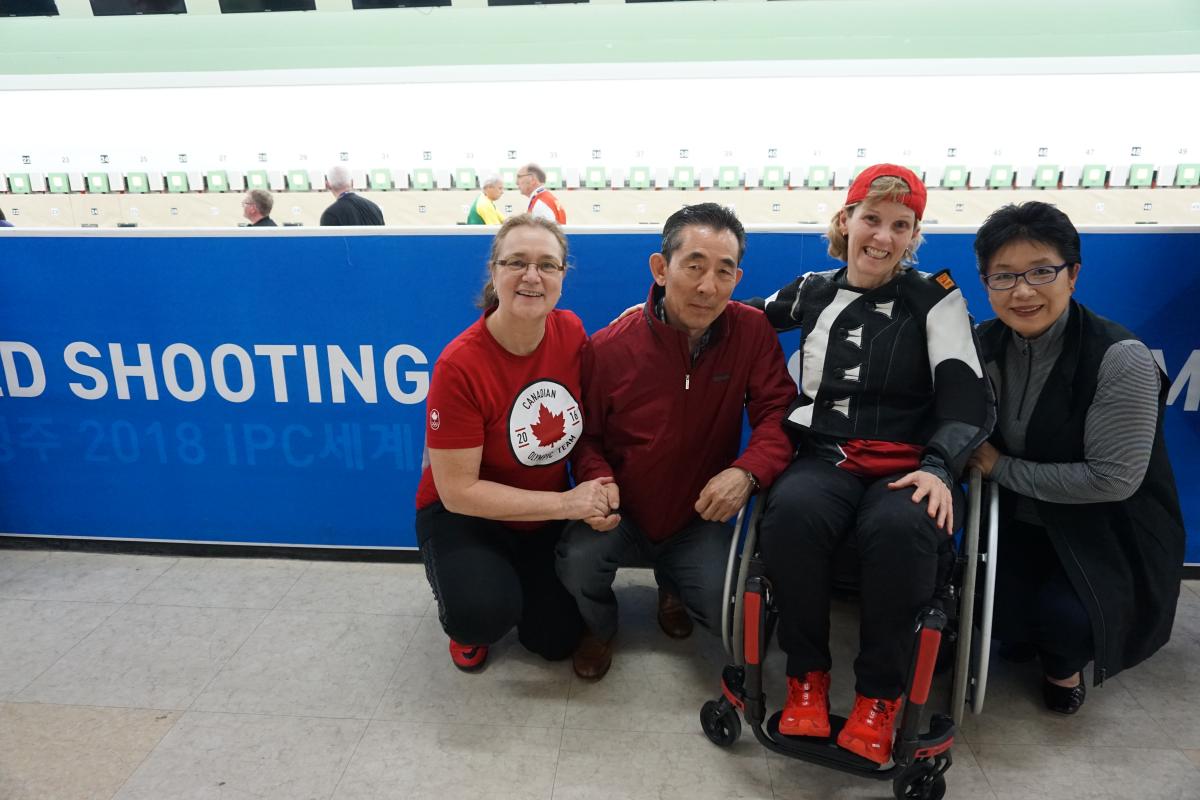 a female Para shooter hugs and smiles with her former coach