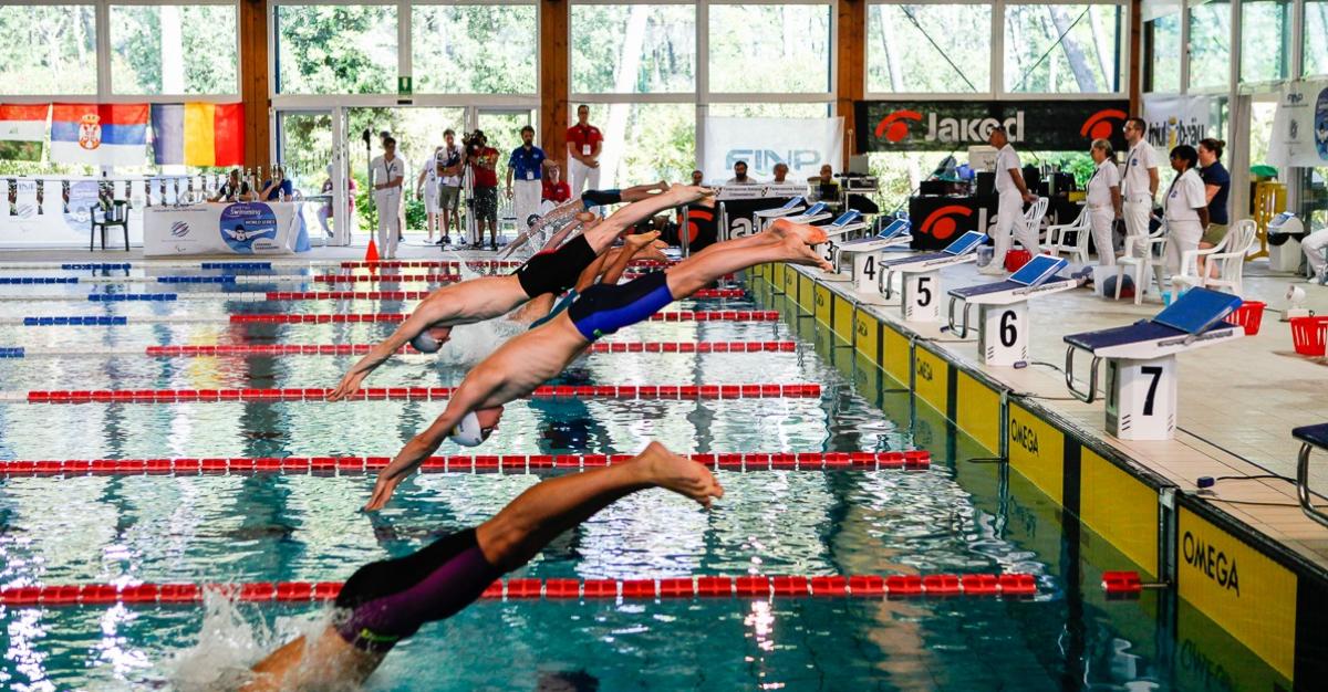 Lignano Sabbiadoro World Series a group of Para swimmers dive into the pool at the start of the race