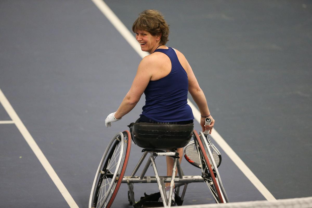 a female wheelchair tennis player on the court